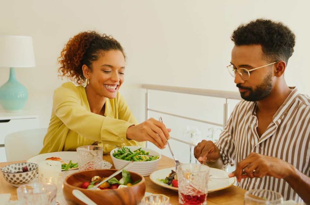 Shot of a young man and woman having lunch together at home